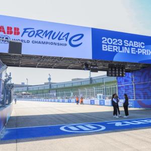 Finish line of a race track, people talking by it.