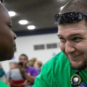 A FIRST mentor encourages a student