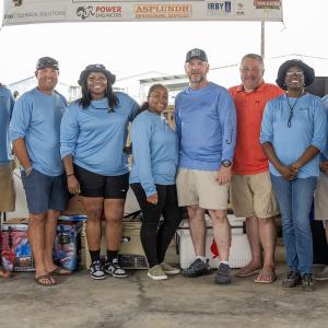 A group posed in matching shirts