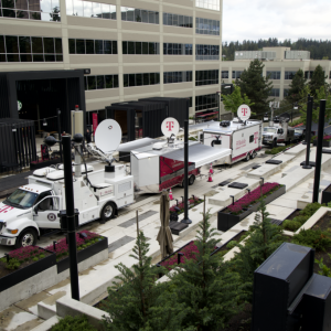 row of trucks with satellite dishes