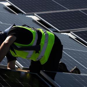 Worker installing polar panels  