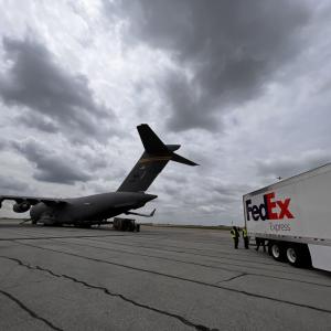 Military plane and FedEx truck