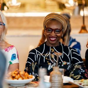 Three people seated at a dining table.