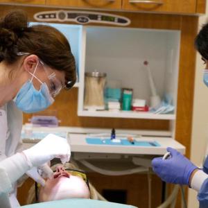 Dentists provide services to a patient in Chicago.