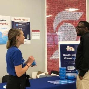 Jacquie and a scotia bank employee at a friendlier booth