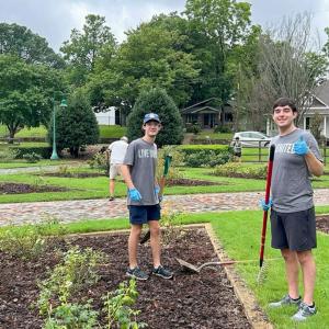 Two intern volunteers gardening.