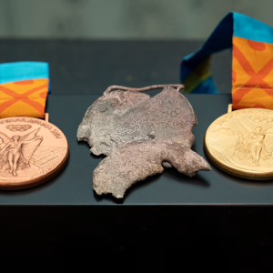 Two new medals on either side of a melted one