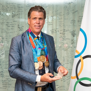Gary Hall Jr. smiling with many new medals around his neck