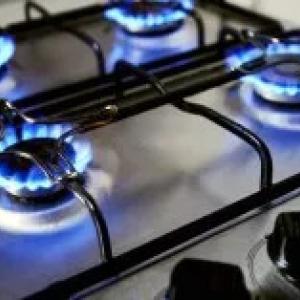 A gas range with all four burners on.
