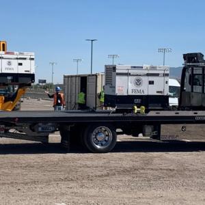 a truck/trailer being loaded with a generator