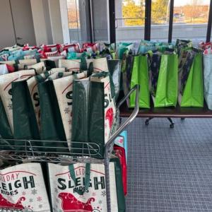 A table and cart full of gift bags.