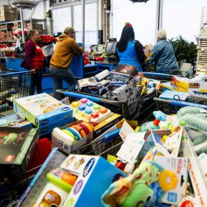 Carts full of toys in a warehouse setting.