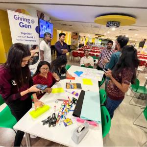 A group of people around a table with crafts and supplies.