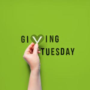 A green background. A hand holding a heart shaped "v" in "Giving Tuesday"
