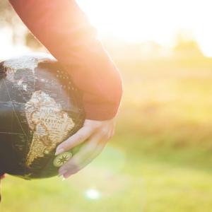 A person holding a globe 