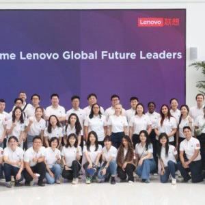 A group posed in matching shirts in front of a sign "Welcome Lenovo Global Future Leaders"