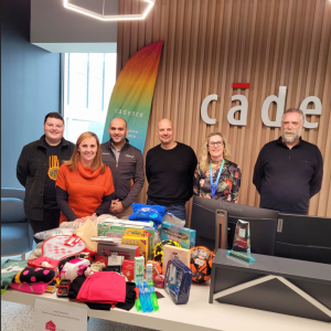 A group of people stood behind a table donation drop off point