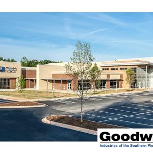 Outside of a Goodwill store and parking lot. The Goodwill logo in the bottom corner.