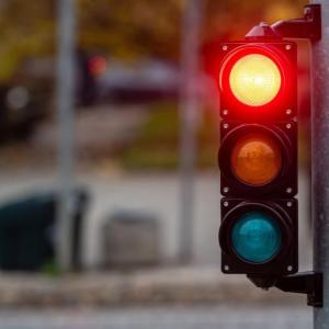 A stoplight shining red.