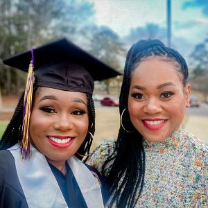 Floresha and another in graduation cap and gown