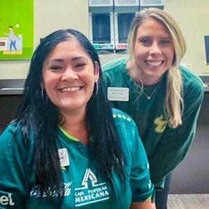 Employees wearing green sweatshirts