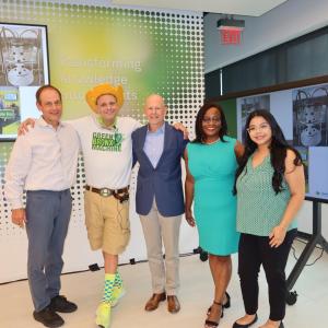 Employees and volunteers posed in a room with displays from "Green Bronx Machine"