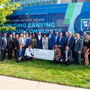 Large group receiving check outside