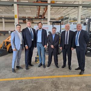 6 people standing together in a factory