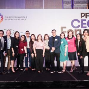 A group of people posed for the camera. Large "PFIP CEO Forum" sign behind them.