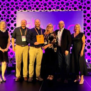 group on stage at event