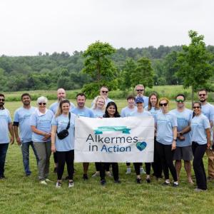 A group of volunteers posed with a sign "Alkermes in Action".
