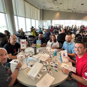 6 volunteers make crafts at a table