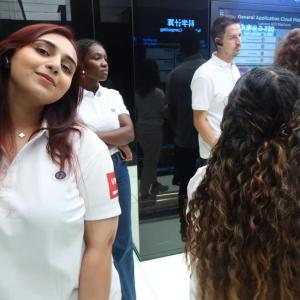 People in matching shirts walking through a display area