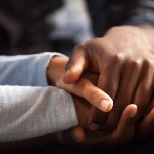 close up of two people holding hands