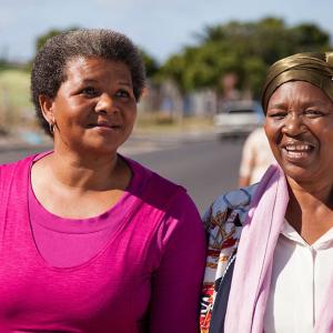 two people walking beside a street