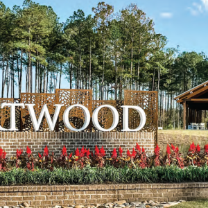 An outdoor sign "Heartwood" and a home in the distance.