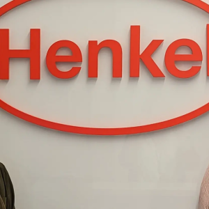 Elizabeth Arredondo and Diana Baker in front of Henkel logo