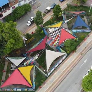 aerial view of colorful triangular tent roofs in between two streets