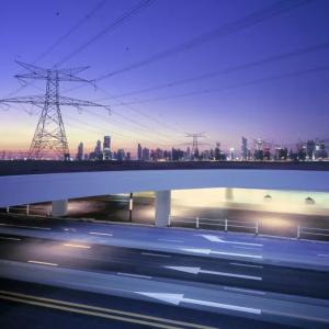 transmission tower with a city skyline in the background