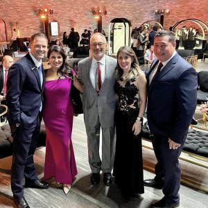 5 people in suits and evening gowns