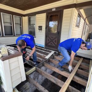 volunteers repairing a house porch