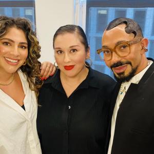 Three People posed with arms around each other.