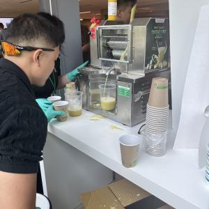 Someone watching a juice machine in action