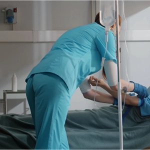 Child getting an IV in a hospital bed