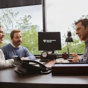 an advisor speaking with two clients