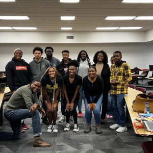 Students all standing in a group smiling at the camera 
