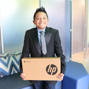 Student holding a HP box