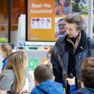 HRH Anne shown with children on DNA Day.