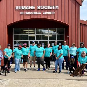  group of volunteers posed outside a building "Humane Society".