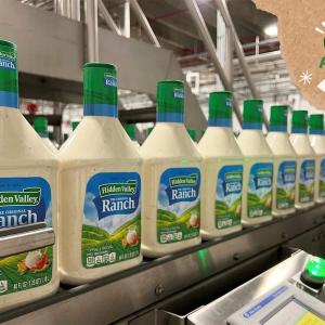 Bottles of Ranch dressing on a conveyor line